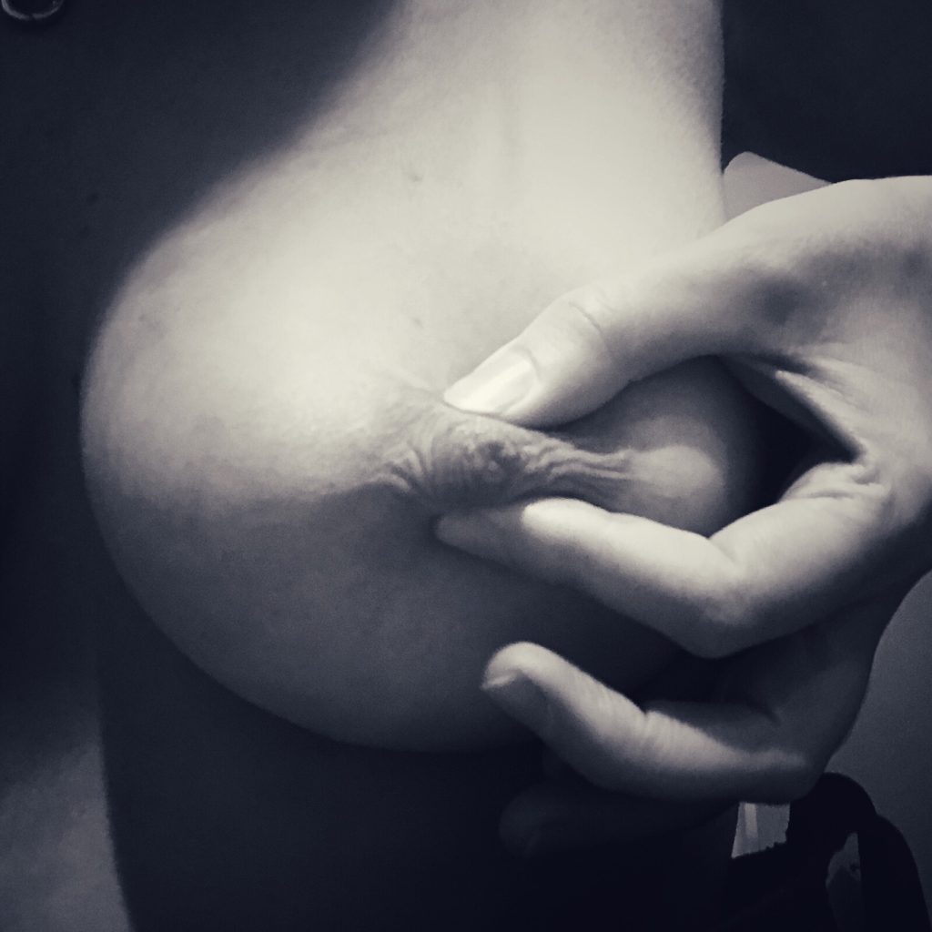 Pinch - a black and white image of my pinching my nipple