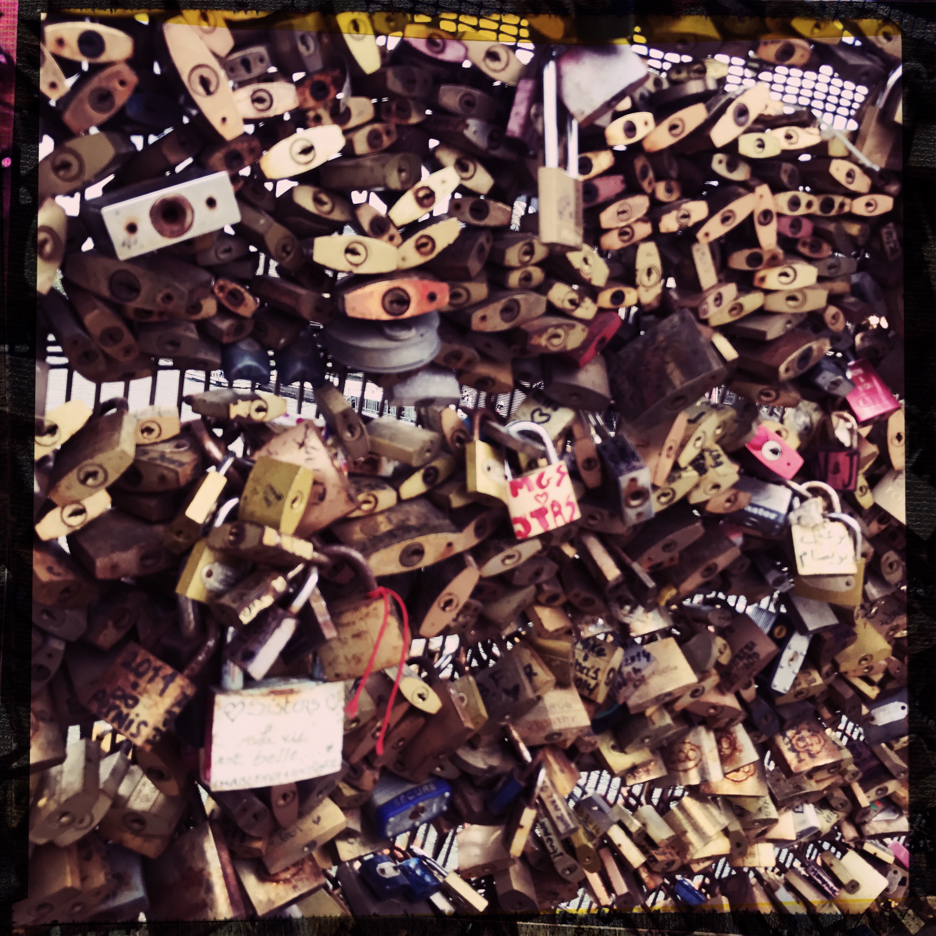 A photo of the padlocks on Pont des Arts in Paris - there are so many padlocks that you can’t see anything else
