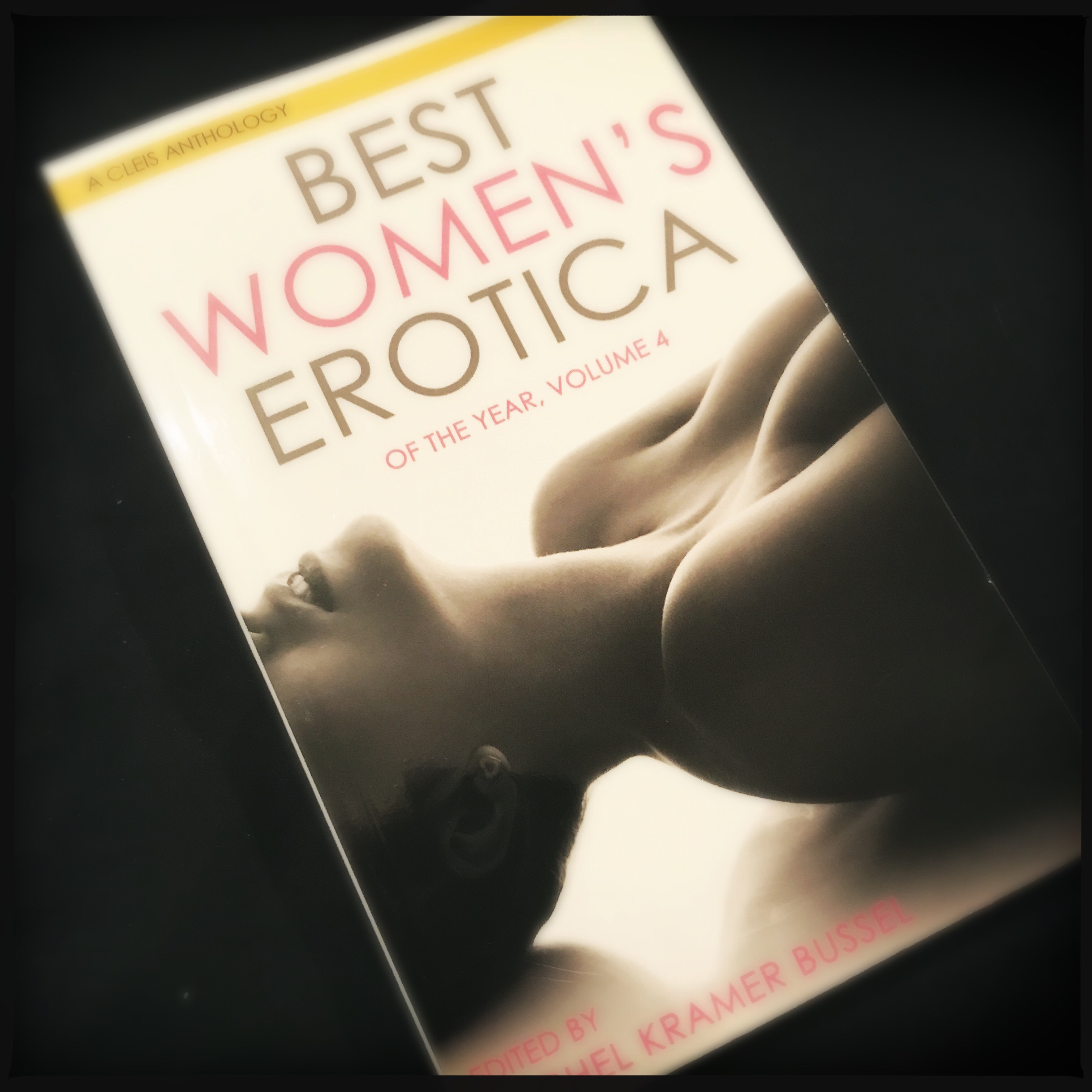 A photo of the cover of Best Women’s Erotica volume 4 on a black background. The cover shows the chin and upper torso of a woman in black and white